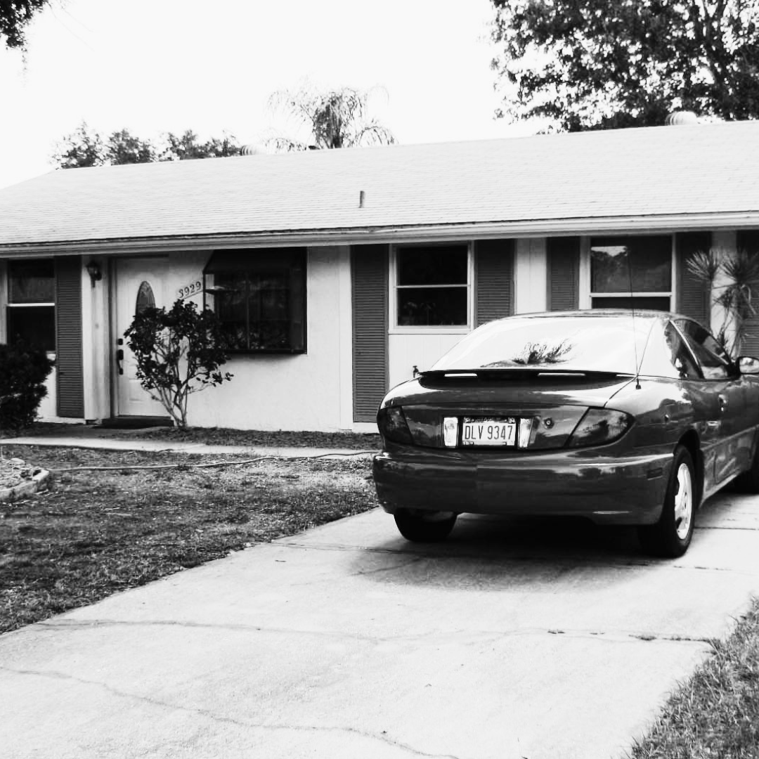 The first house in Sarasota with the red Pontiac Sunfire parked outside