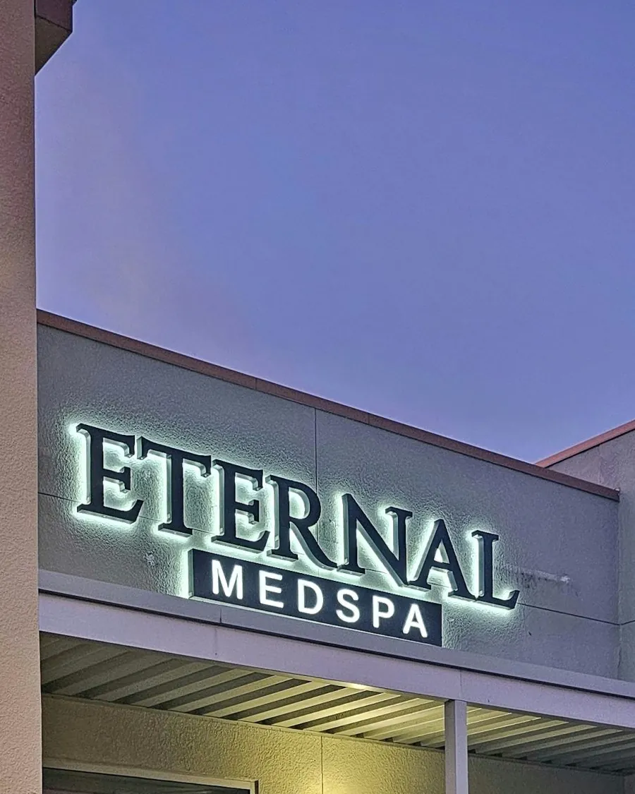 Lit Eternal MedSpa sign on the Sarasota clinic at dusk