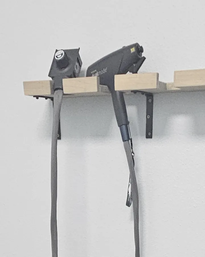 DualMode laser handpiece on the wall rack in the laser room at Eternal MedSpa Sarasota