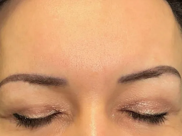 After: the same guest's brows, after permanent makeup